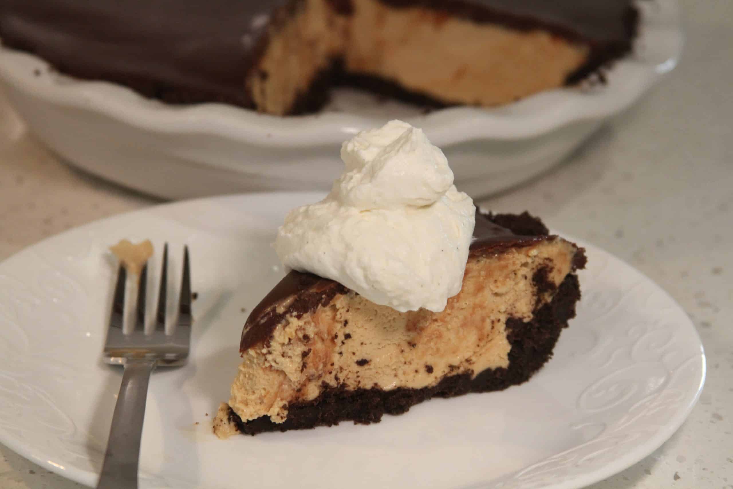slice of no bake peanut butter pie with oreo crust and chocolate ganache on white plate