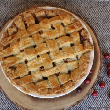 apple pie with flaky crust, on table ready for thanksgiving